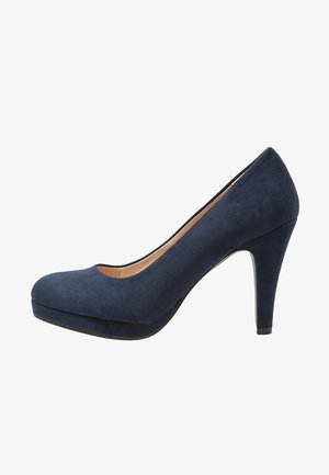 Chaussure femme à talons hauts en daim bleu marine, avec un bout rond et une semelle à plateforme, photographiée sur un fond blanc.