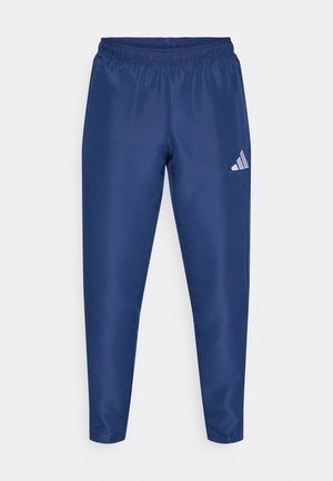 Marineblauwe sportbroek met een elastische tailleband, taps toelopend ontwerp en een klein wit logo op het linkerbeen. Gladde, lichtgewicht stoftextuur.