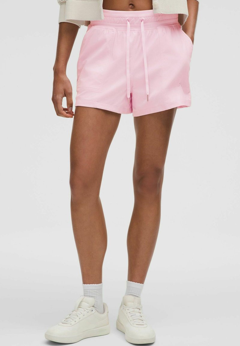 Pink shorts made of lightweight fabric, with an elastic waistband and drawstring. Features side pockets and a relaxed fit.