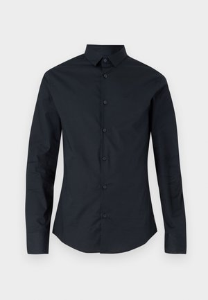 Schwarzes Langarmhemd mit spitzem Kragen, Knopfverschluss auf der Vorderseite und slim-fit Schnitt. Hergestellt aus glattem Stoff, mit dezentem Logo-Stick. 