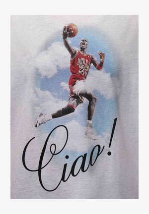 Red graphic t-shirt featuring a jumping basketball player in a Bulls jersey, with “Ciao!” printed in black cursive. Background shows clouds.