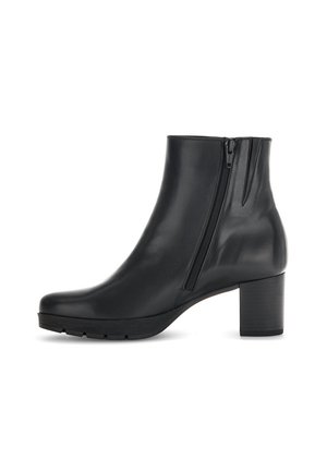 Bottine noire en cuir lisse, avec une fermeture éclair sur le côté, un bout arrondi et un design de talon épais. Semelle texturée pour l'adhérence.