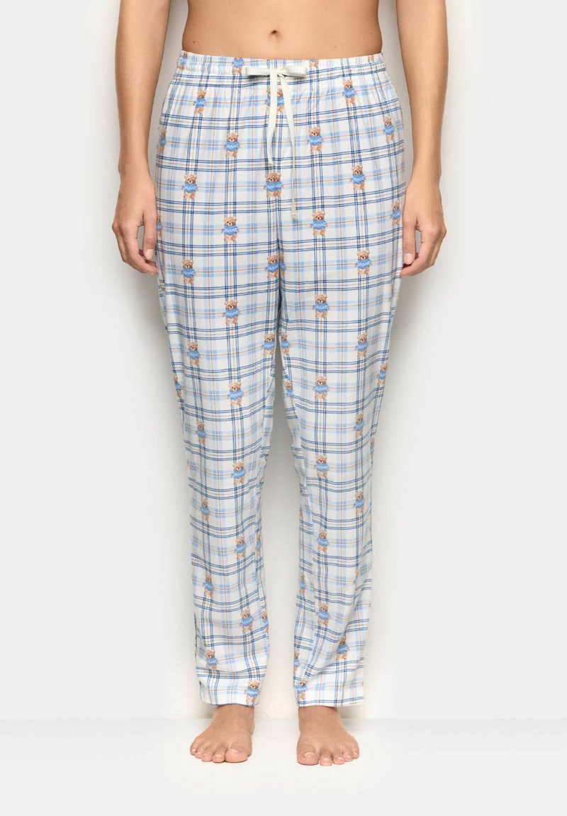Lyseblåternet natbukser lavet af blødt stof med et mønster af små bjørne, med elastisk talje og justerbar snor.