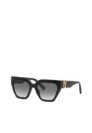 Lunettes de soleil carrées surdimensionnées noires avec des verres dégradés gris et des accents décoratifs dorés sur les branches.