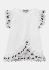 Biała koszulka z falbaniastymi rękawami, z granatowym haftem kwiatowym i falbaniastymi krawędziami. Asymetryczny krój z fakturowanej tkaniny.