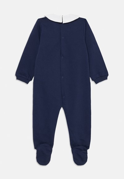 Navy Baumwoll-Overall mit langen Ärmeln, weißem Peter-Pan-Kragen und Fußdesign. Mit Druckknöpfen auf der Rückseite für ein einfaches Ankleiden.