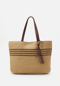 Torba ze słomy z brązowymi skórzanymi uchwytami, z poziomymi brązowymi paseczkami i ozdobnym frędzlem. Teksturowany, pleciony wzór.