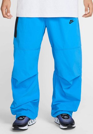 TECH - Tracksuit bottoms - light photo blue