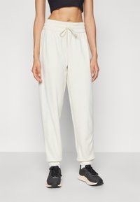 New Balance WARMING PERFORMANCE JOGGER - Jogginghose - offwhite