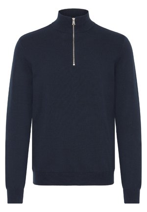 Merinotakki laivastonsinisen värin ja neulottuja kuituja, pitkät hihat, istuvat hihansuut ja suora helma. Kaulassa on hopean värinen vetoketju.