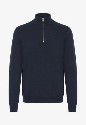 Merinotakki laivastonsinisen värin ja neulottuja kuituja, pitkät hihat, istuvat hihansuut ja suora helma. Kaulassa on hopean värinen vetoketju.