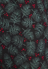 Tyget har en svart bakgrund med ett upprepande mönster av gröna tallkvistar och röda bär, vilket kombinerar textur och färg.