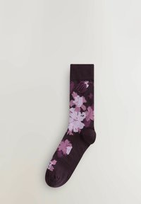 Chaussette violette foncée avec un motif floral dans des teintes de rose et de lilas, dotée d'une bordure côtelée et d'une texture lisse.