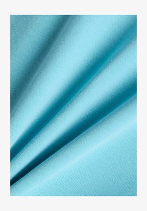 Tissu bleu clair avec des plis doux mettant en valeur une texture lisse et un détail de maille fine.