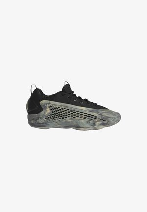 Zapatillas deportivas negras con parte superior de malla, talón texturizado en negro y suela semitranslúcida con patrones grises en espiral y detalles recortados.