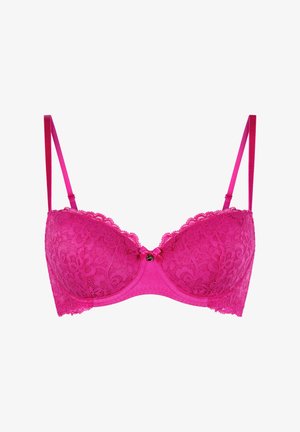 Soutien-gorge rose en dentelle avec armatures, bonnets rembourrés et bretelles réglables. Il présente des détails en dentelle florale et un petit nœud au centre avant.