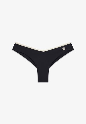 Schwarzer niedrig sitzender Tanga mit beigem Rand und kleinem weiß besticktem Logo auf der linken Seite.