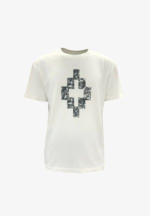Witte T-shirt met korte mouwen en een zwart-wit pixelachtig kruisontwerp, gevormd door een patroon van slangenhuid, centraal op de voorkant.