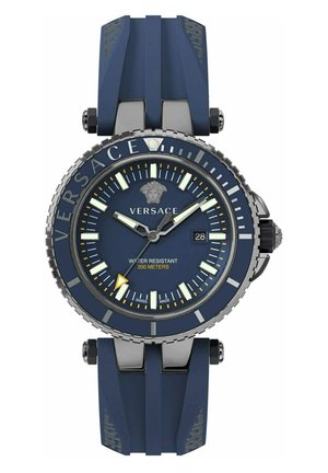 Navy rubber watch with stainless steel accents, a textured bezel, and a round dial featuring luminous hands, date display, and a Medusa logo.