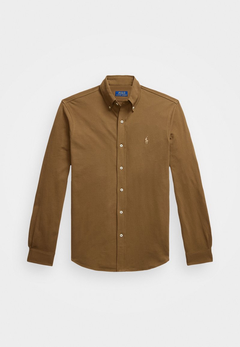Camicia a maniche lunghe color marrone, con bottoni, realizzata in cotone. Presenta un colletto, chiusura frontale con bottoni e un piccolo logo ricamato sul petto.