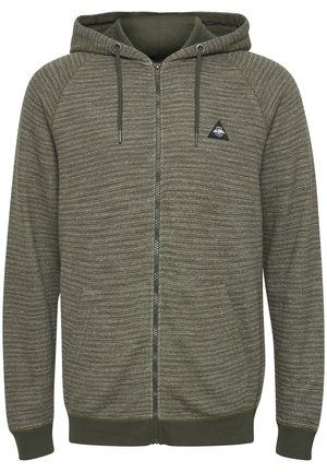 Olive green zip-up hoodie in textured fabric, featuring a triangular logo, raglan sleeves, and drawstrings on the hood.