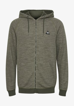 Olive green zip-up hoodie in textured fabric, featuring a triangular logo, raglan sleeves, and drawstrings on the hood.