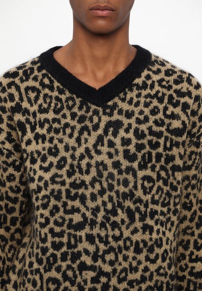 Animal print sweater featuring a v-neck design, made of soft fabric in shades of beige and black with a textured pattern of leopard spots.