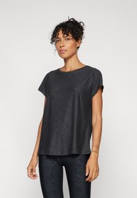Black short-sleeve top with a smooth finish, featuring a subtle textured pattern. The design has a relaxed fit and crew neck.