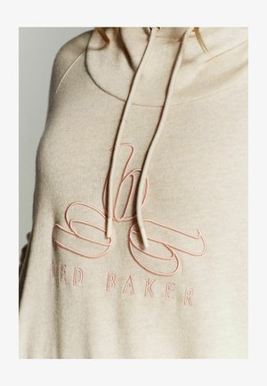 Bež kapuutsviit koos tonal roosa broderitud logoga ja paeltega, omades pehmet tekstuuri ning lõtvade joonte disaini.