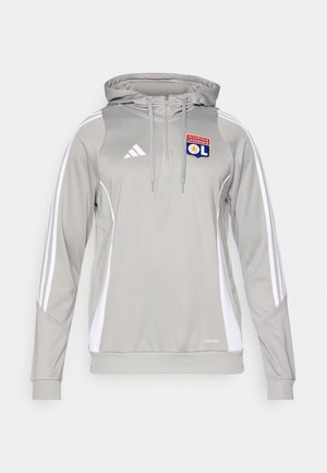 Sivi sportski dukserica s bijelim bočnim panelima i tri bijele pruge na rukavima. Sadrži prednji patentni zatvarač, kapuljaču s uškićem i izvezeni logo.