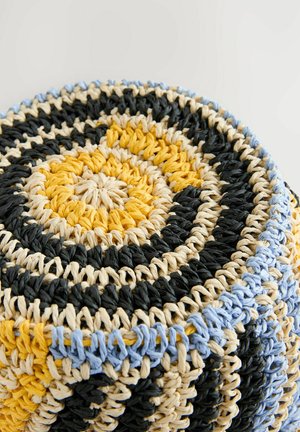 Round woven basket featuring black, yellow, cream, and blue stripes. Made from textured material with a spiral design.