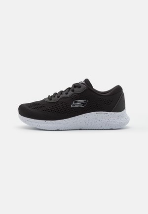 Black Skechers athletic shoe with breathable mesh upper, white speckled foam sole, and side logo, viewed from the outer side.