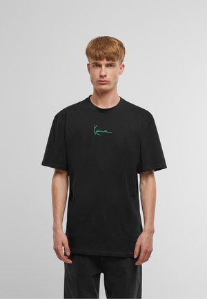 Black cotton t-shirt with short sleeves, featuring a turquoise handwritten logo on the chest. Crew neck design, relaxed fit.