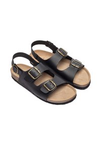 Sandales en cuir noir avec trois sangles réglables et boucles dorées, semelle en liège et semelle beige texturée. Design à dos ouvert.