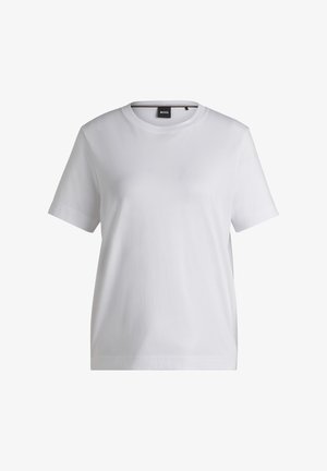 T-shirt de algodão branco com decote redondo, mangas curtas e um corte descontraído. Apresenta uma pequena etiqueta da marca perto do colarinho.
