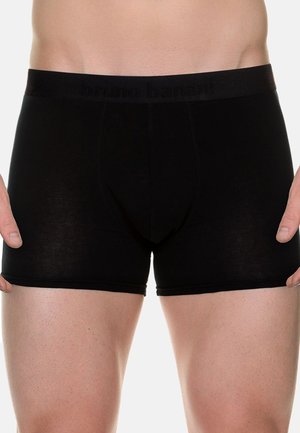 Schwarze Boxershorts aus weichem Material, enganliegendem Design und elastischem Bund mit eingeprägtem Branding. Mittlere Oberschenkelänge, minimale Nähte.