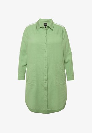 Vihreä napitettava paita, jossa on kaulus, kolmivartiset hihat, etupocketit ja sivuraidat. Valmistettu kevyestä, teksturoidusta kankaasta.