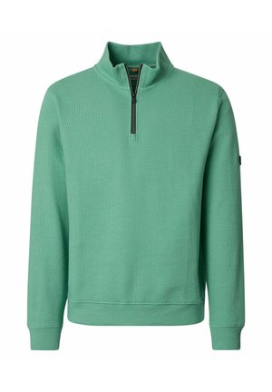 Lysegrøn langærmet pullover med halvlange lynlås-krave, tekstureret stof, ribstrikkede manchetter og linning, vist på en ensfarvet hvid baggrund.