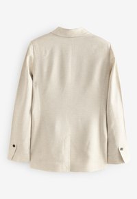 Beige blazer met een slank silhouet, gladde textuur, revers met inkeping en manchetten met knopen. Voorzien van een centrale achterventilatie voor bewegingsvrijheid.