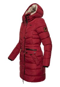Red padded winter coat with a furry-lined hood, multiple pockets, and a zip closure. Features quilted design and ribbed cuffs.