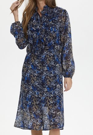 Bloemenjurk met lange mouwen tot op de knie, met blauw, wit en beige patronen, met een gerimpeld voorpand en een getailleerde taille.