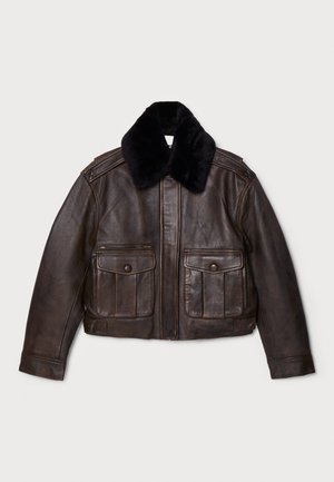 Giacca di pelle marrone con collo in pelliccia nera, chiusura con zip, due ampie tasche a patta, design su misura e finitura testurizzata.