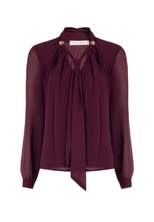 Blusa bordeaux realizzata in tessuto trasparente con collo a fiocco, maniche lunghe e dettagli dorati sul collo. Tessuto morbido, design elegante.