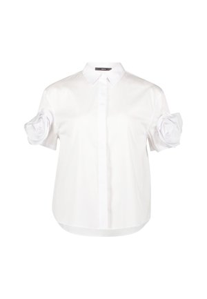 White short-sleeve shirt made of smooth fabric, featuring a collared neckline and unique fabric flower detail on the left sleeve.