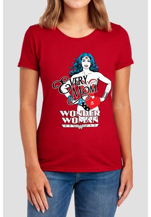 Woman wearing a red t-shirt with a Wonder Woman illustration and the text "Every mom is Wonder Woman" in white and red letters.