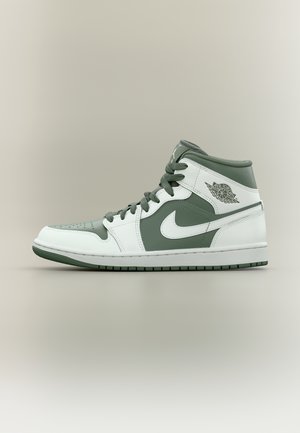 Wysokie sneakersy Nike Air Jordan w białym i stonowanym zielonym kolorze z widocznym znakiem Swoosh oraz logo skrzydeł Air Jordan z boku.