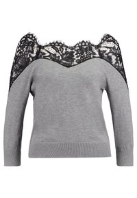 Un pull gris avec un décolleté en dentelle noire à épaules nues. Manches longues et texture en maille avec poignets et ourlet côtelés.