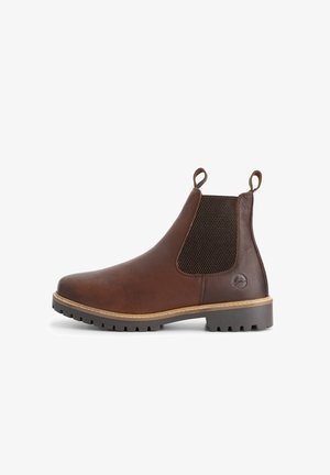 Bruine leren Chelsea-boot met zwarte elastische zijpanelen, aantrek-lussen op de hiel en enkel, en een robuuste donkere zool met lichte stiksels.