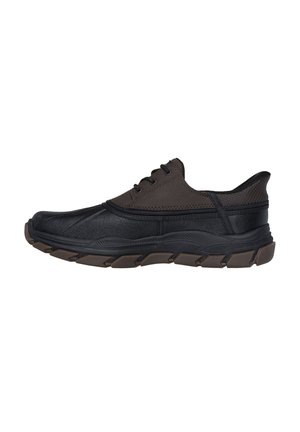 Black and brown athletic shoes with a textured exterior, lace closure, and a thick, patterned brown rubber sole designed for comfort.