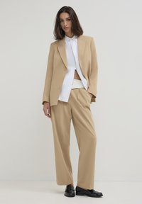 Calliope CON FASCIA ASIMMETRICA  - Stoffhose - beige